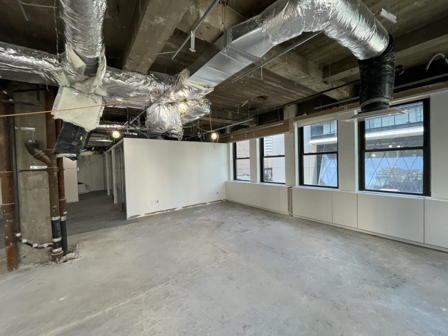 Commercial office space with new HVAC ductwork installed by Irving Haase